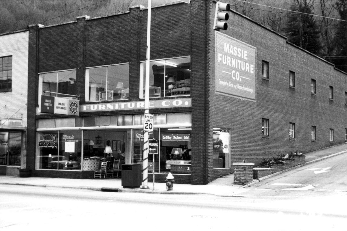 Massie Furniture Co. corner store with a GE appliances sign and painted wall ad at Main and Spring streets in Sylva, NC