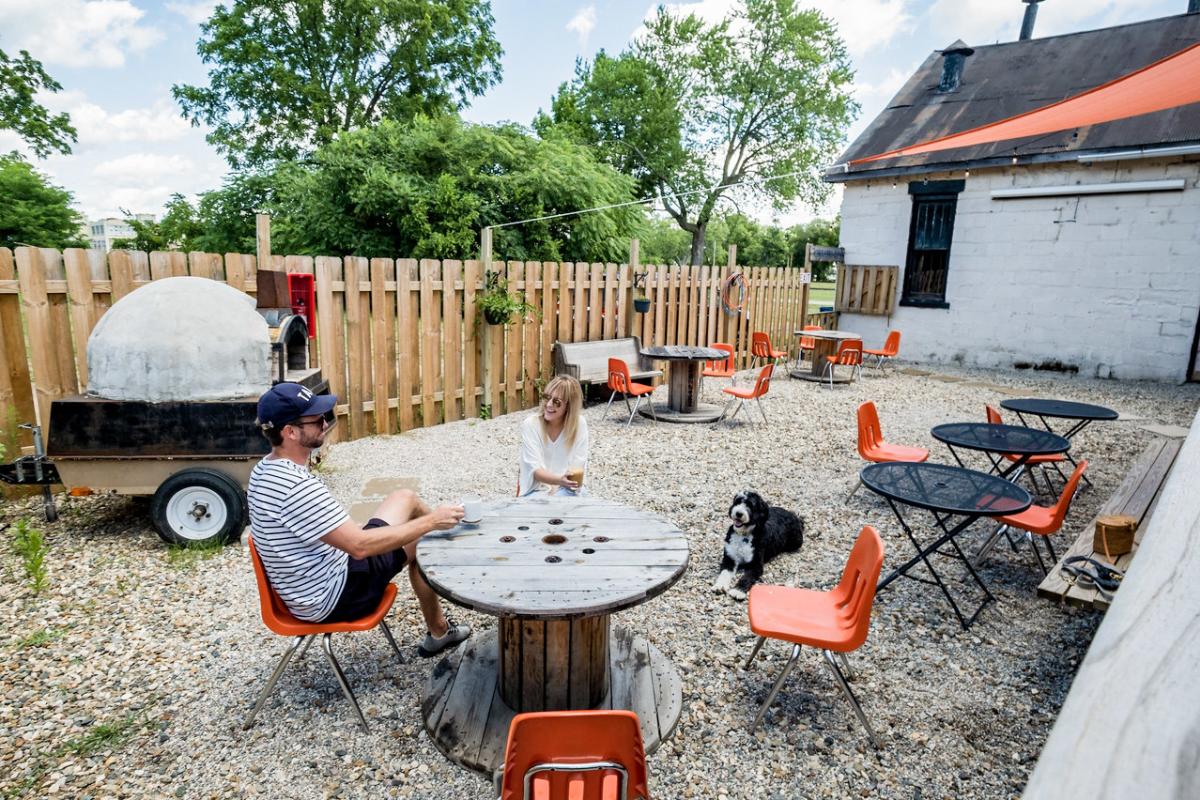 2 people sitting outside at a table