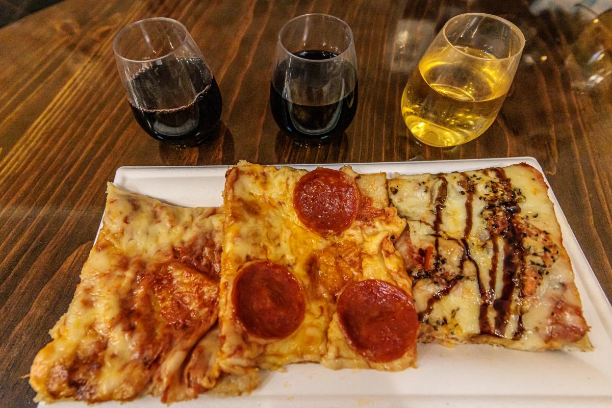 Three slices of pizza are paired with three different wines during Kalamazoo Craft beverage Week