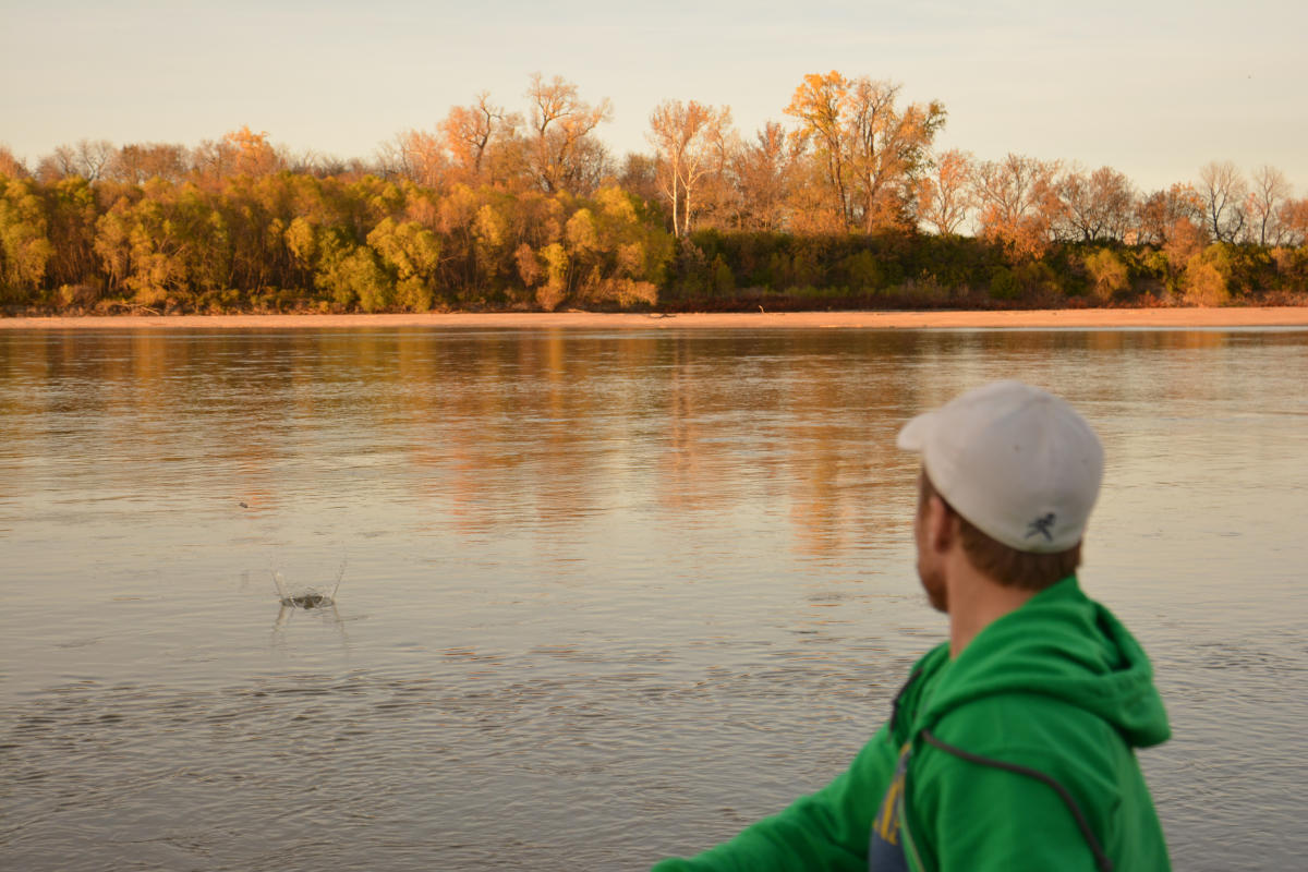 Man stands in front of the Kaw River