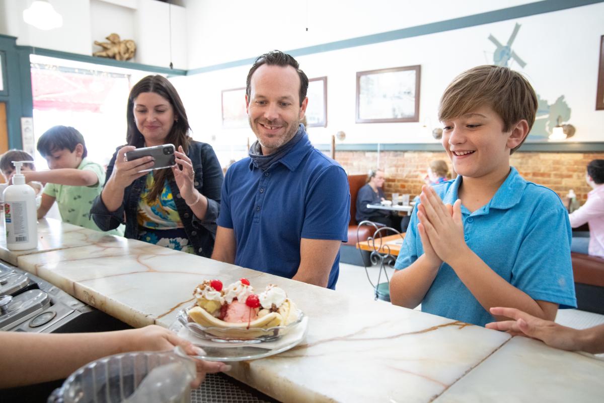 A family enjoys a banana split at Old Mill Tasty Shop