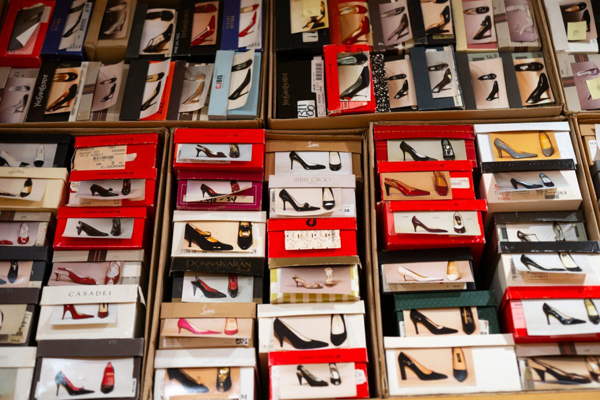 stacks of shoe boxes with pictures of the shoes on the front