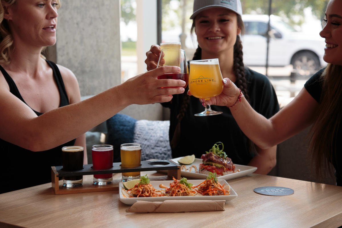 A group of friends toasting beers at Shoreline Brewing