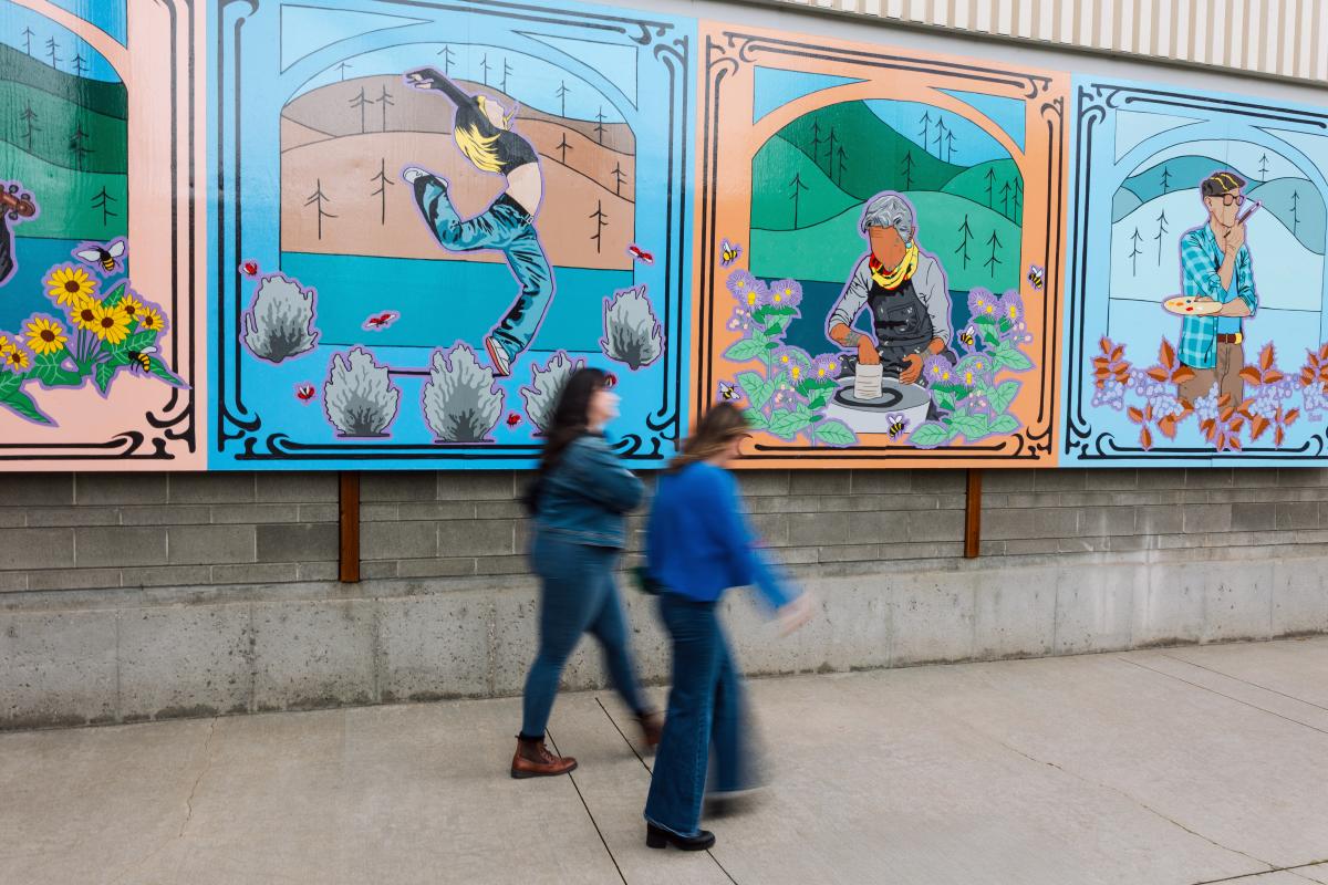 People walking in front of artwork outside of the Rotary Centre for the Arts