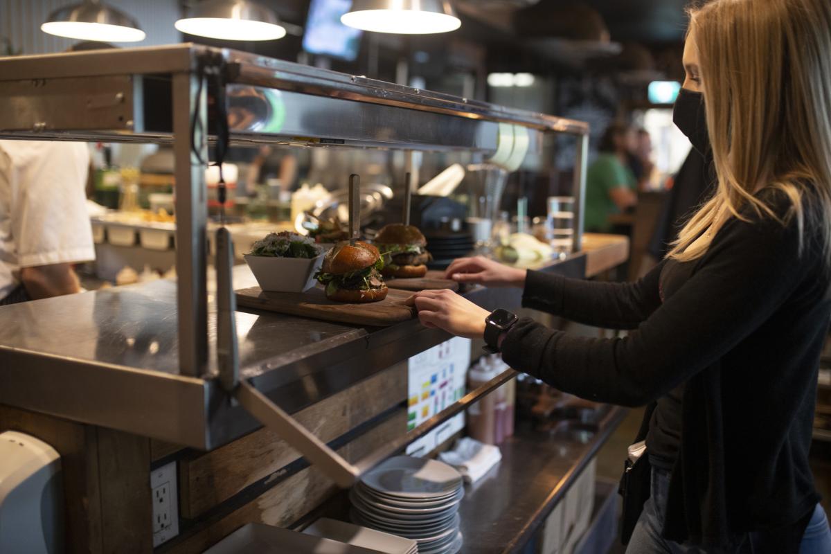 Central Kitchen + Bar, Server wearing mask with food