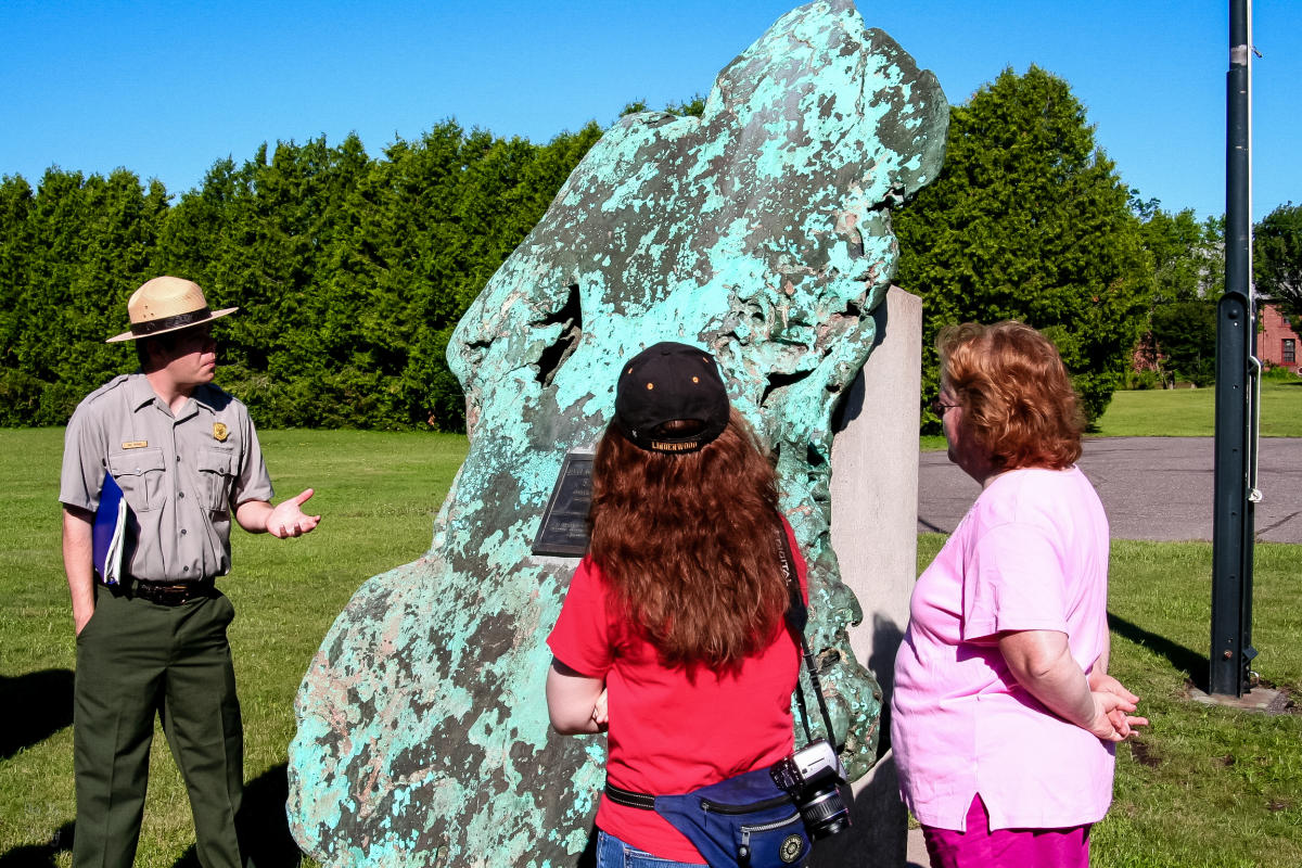 Ranger gives talk next to large piece of copper