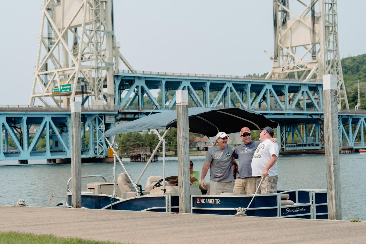 Friends on pontoon near lift bridge.