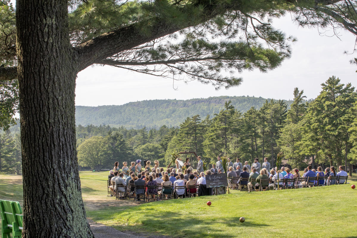 Outdoor wedding at Keweenaw Mountain Lodge with forested mountain behind.