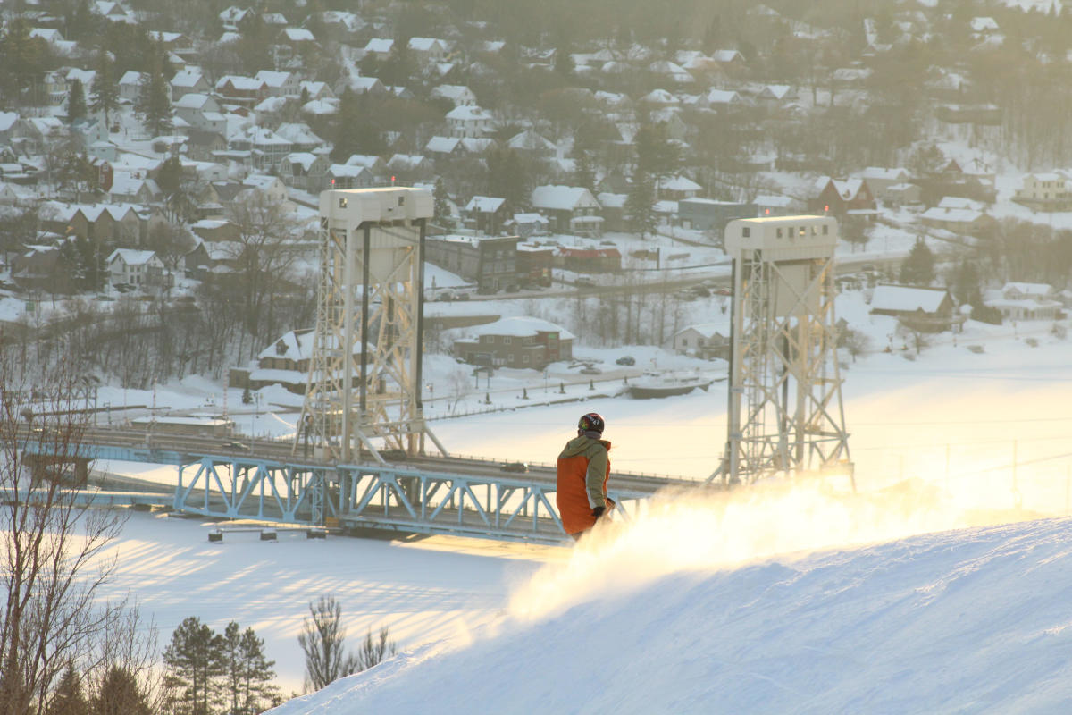 Mont Ripley Skier with Portage Lake Lift bridge in backgroud.
