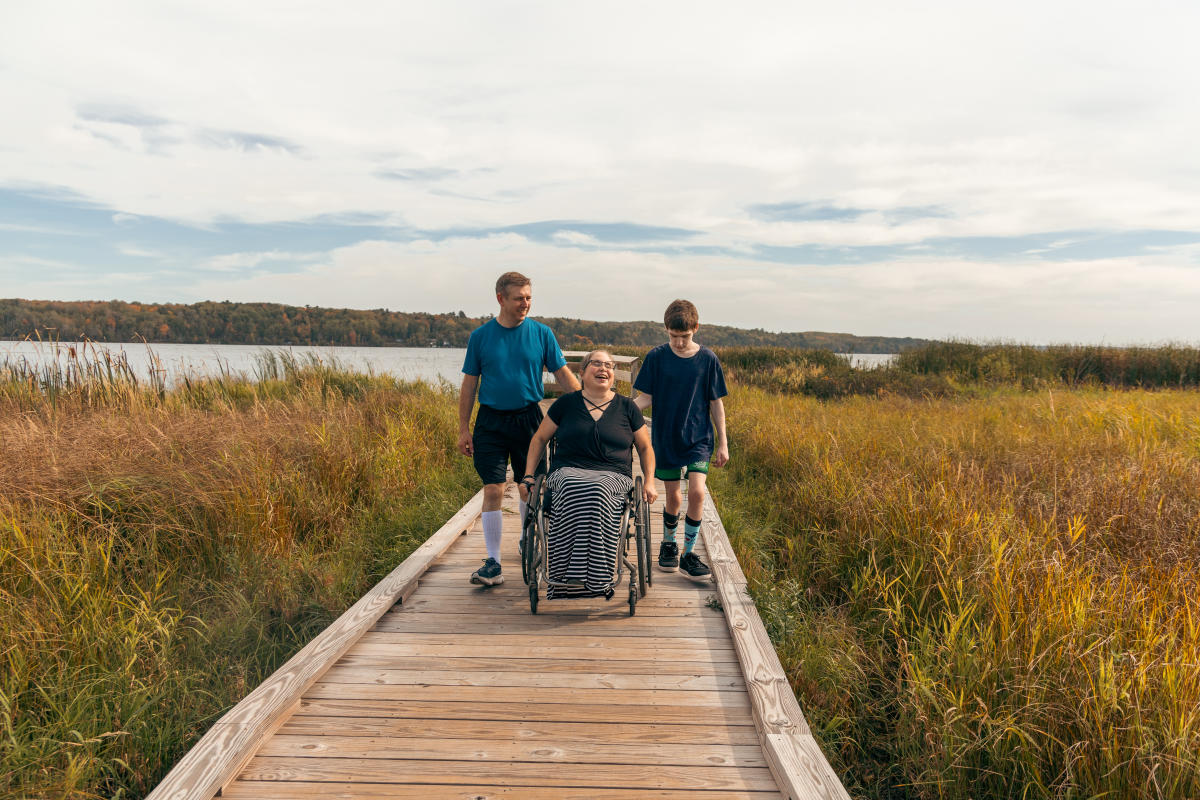 family on accessible boardwalk trail in wetlands