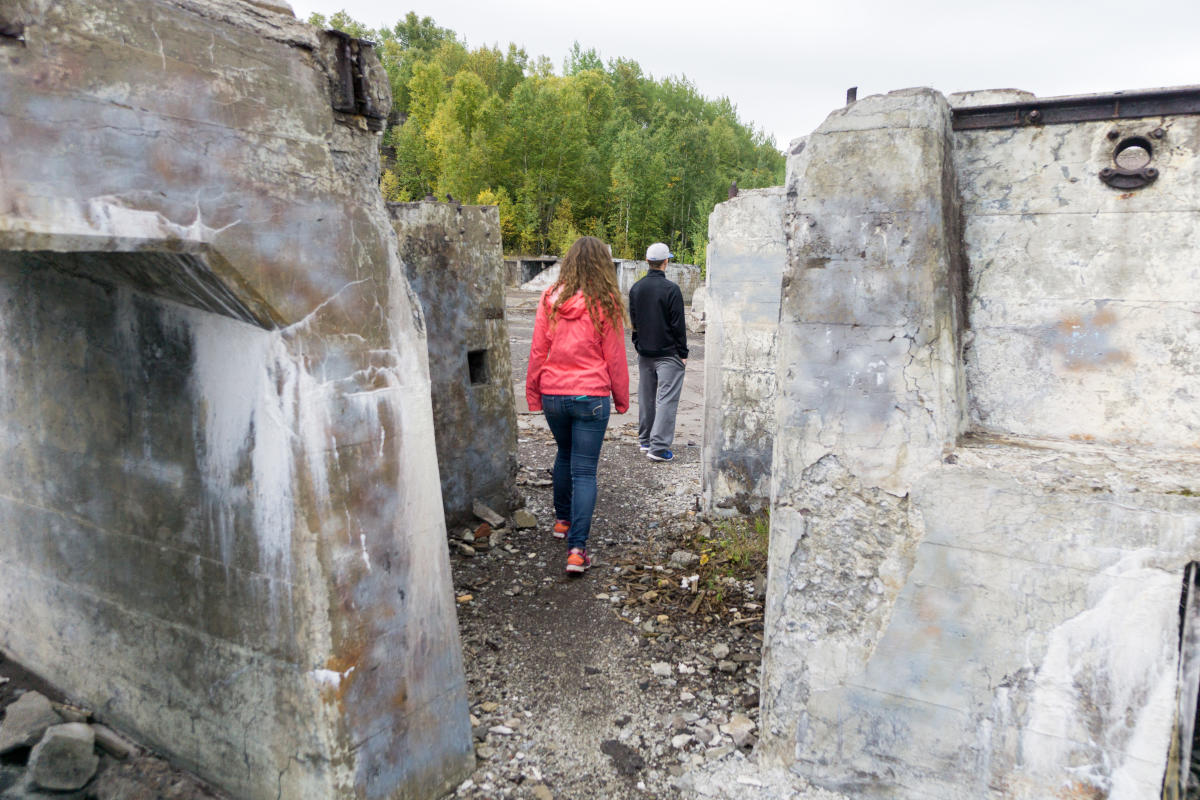 People walking through concrete ruins at Freda