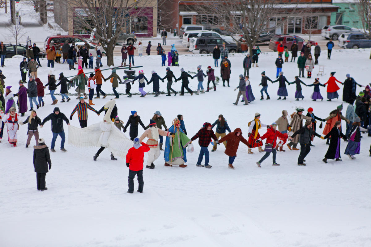 people dance in a spiral