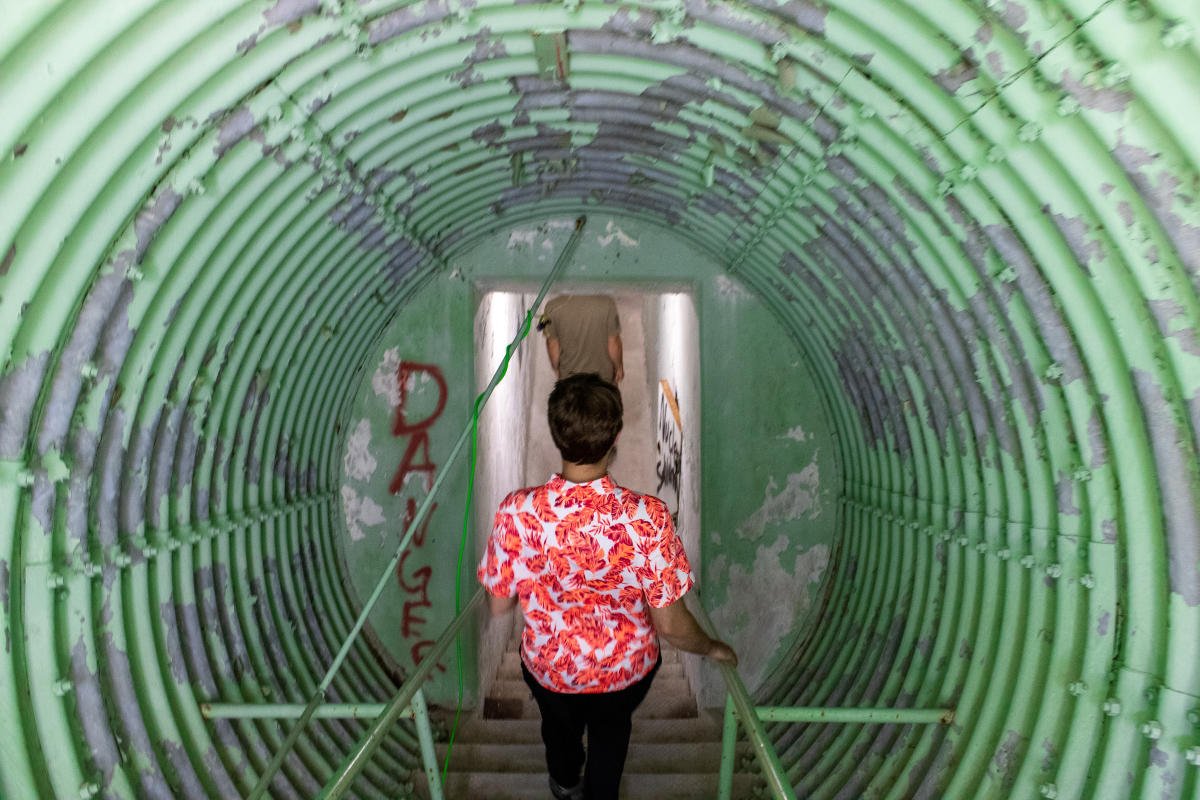 Man goes down into underground bunker at radar base.