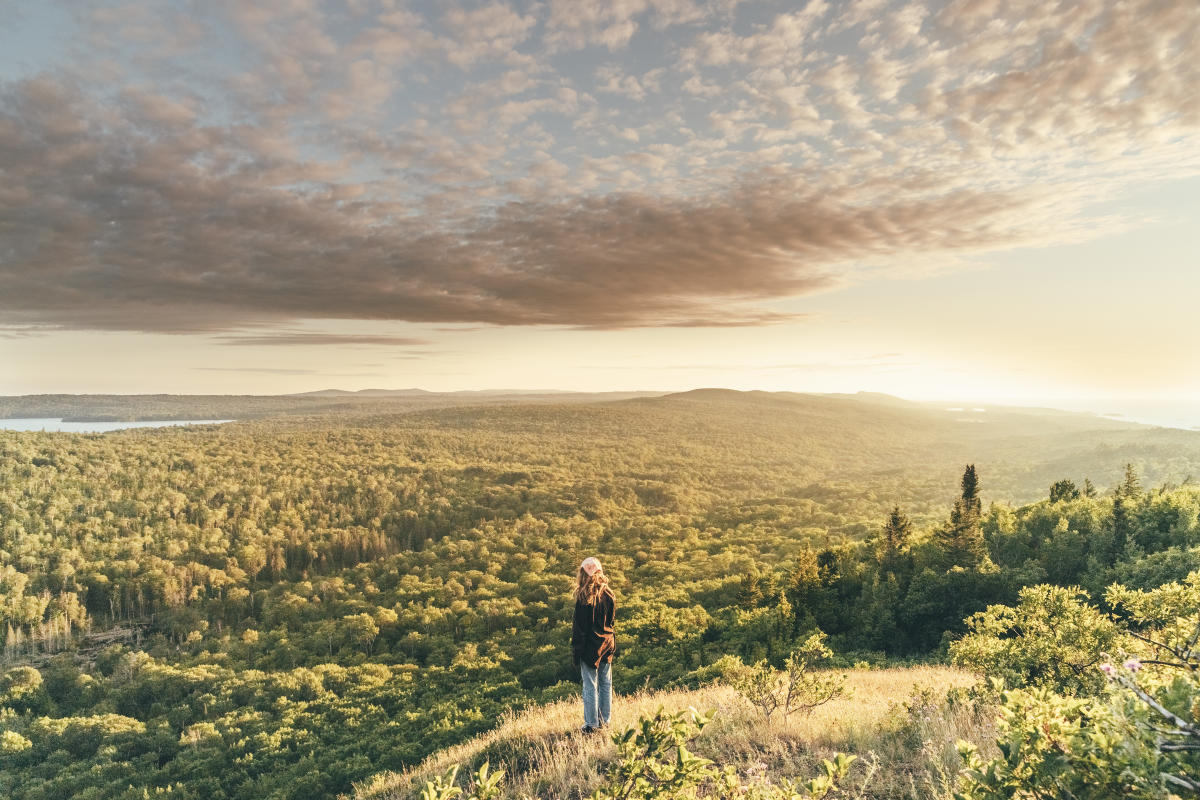 Young woman viewing the vast wilderness in the Keweenaw