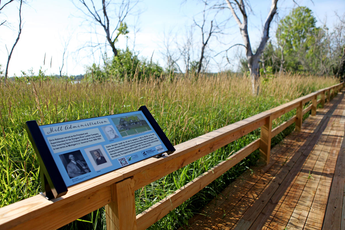 Signage along boardwalk on Chassell Historic Trail shares history of the town.