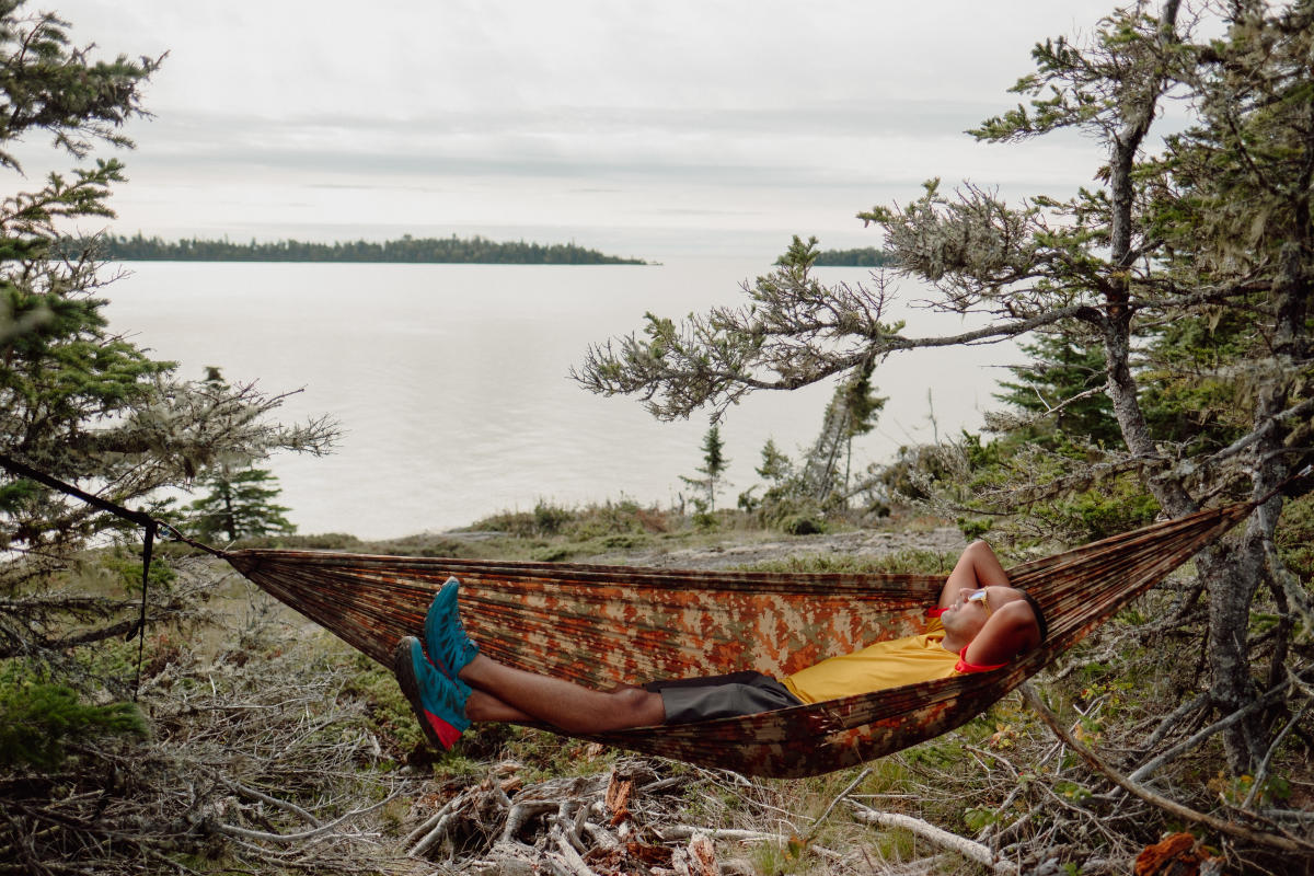 Man lays in hammock on Isle Royale