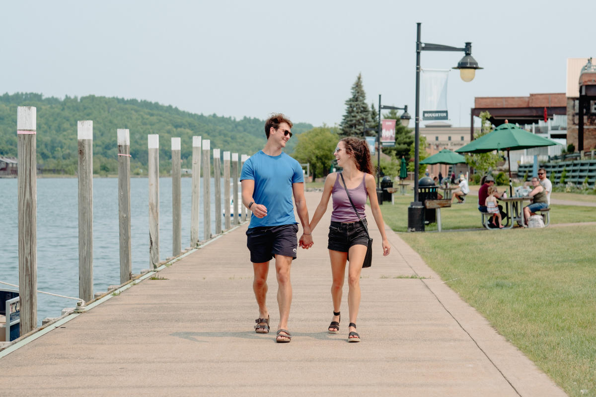 A couple walks along the waterfront trail in Houghton