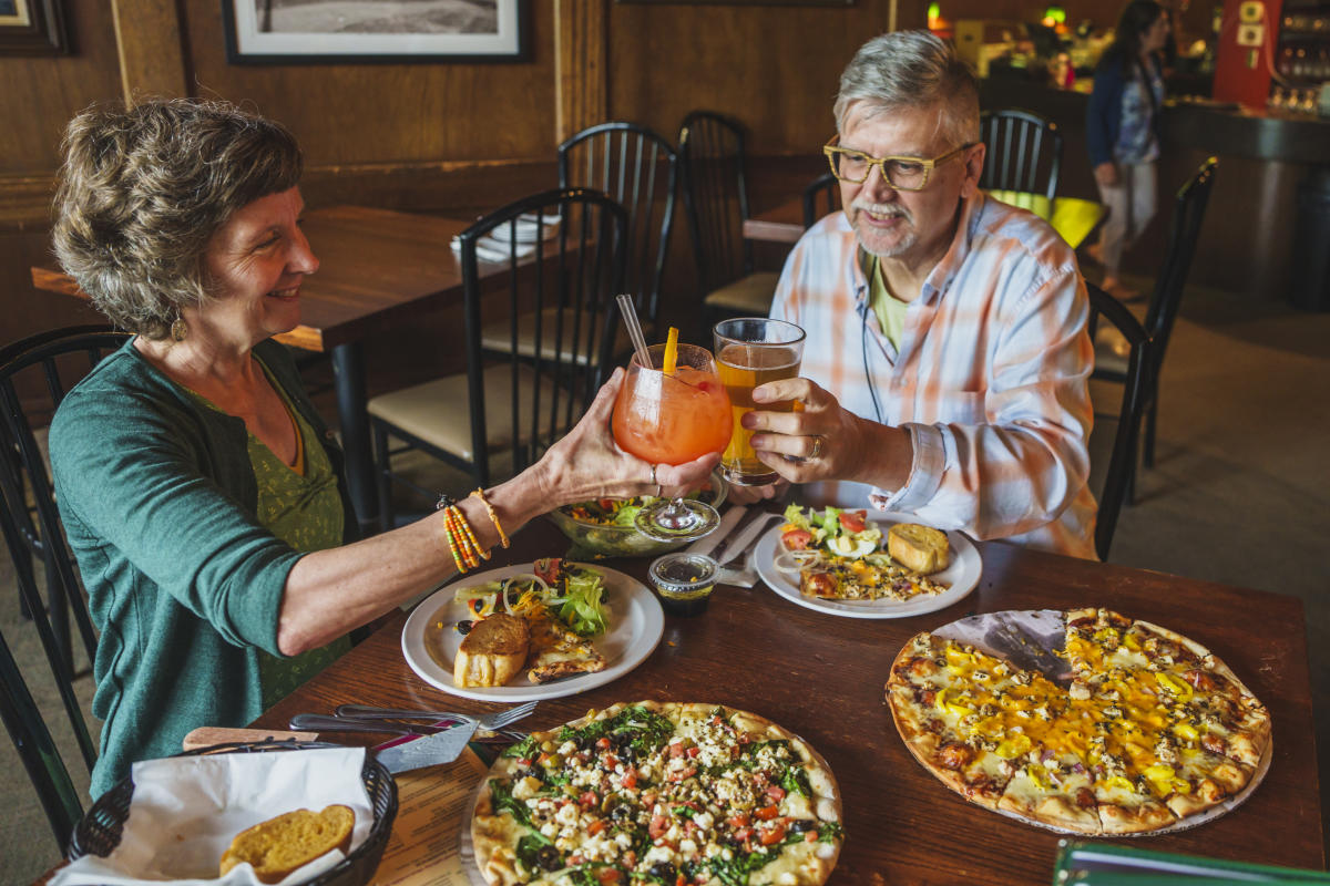 a couple cheers cocktails over pizzas