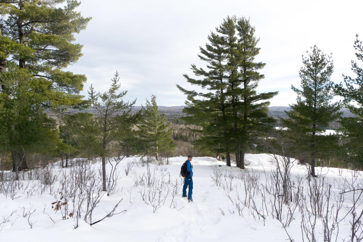 A snowshoer pauses for a photo on Little Mountain.