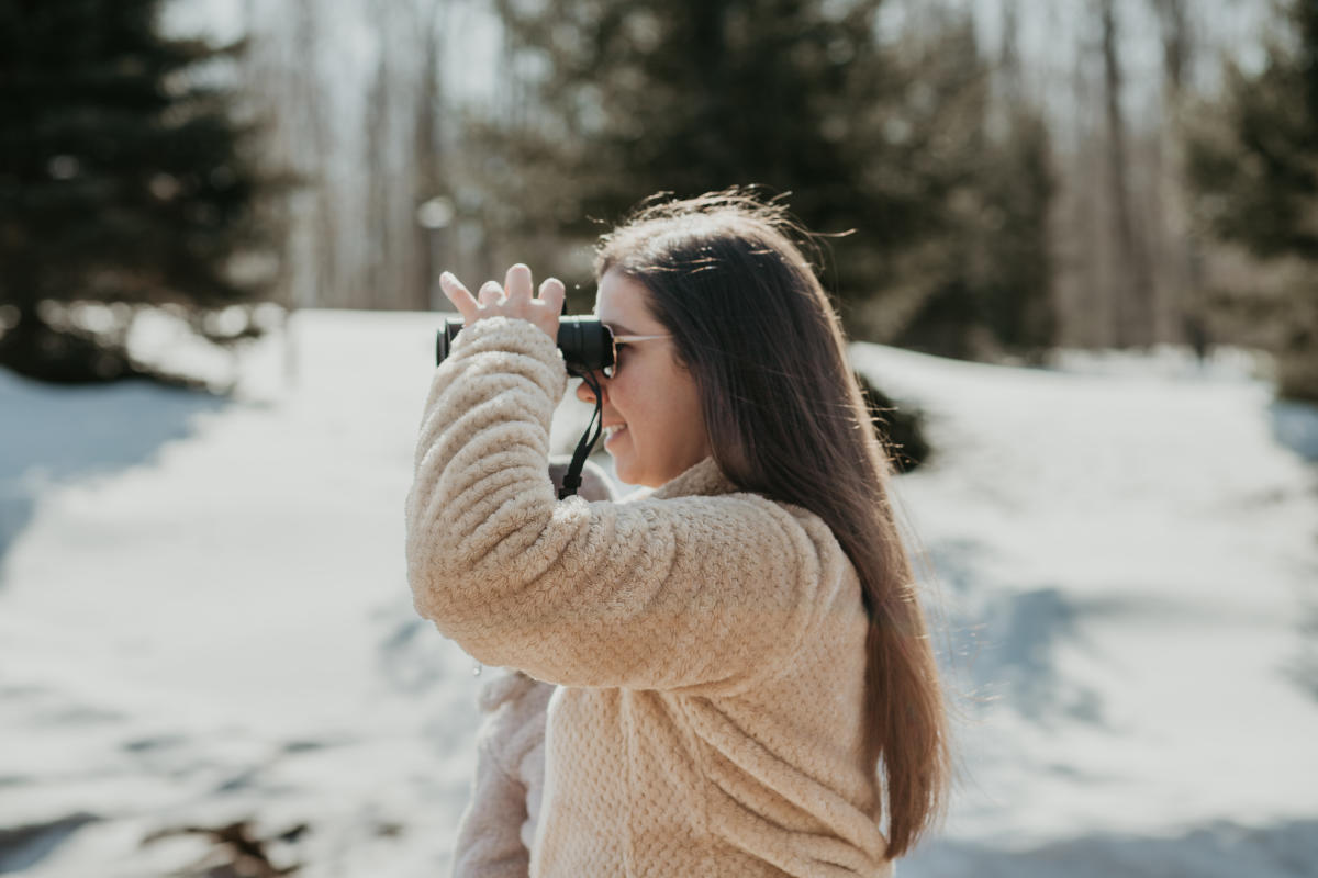 Woman looks through binoculars