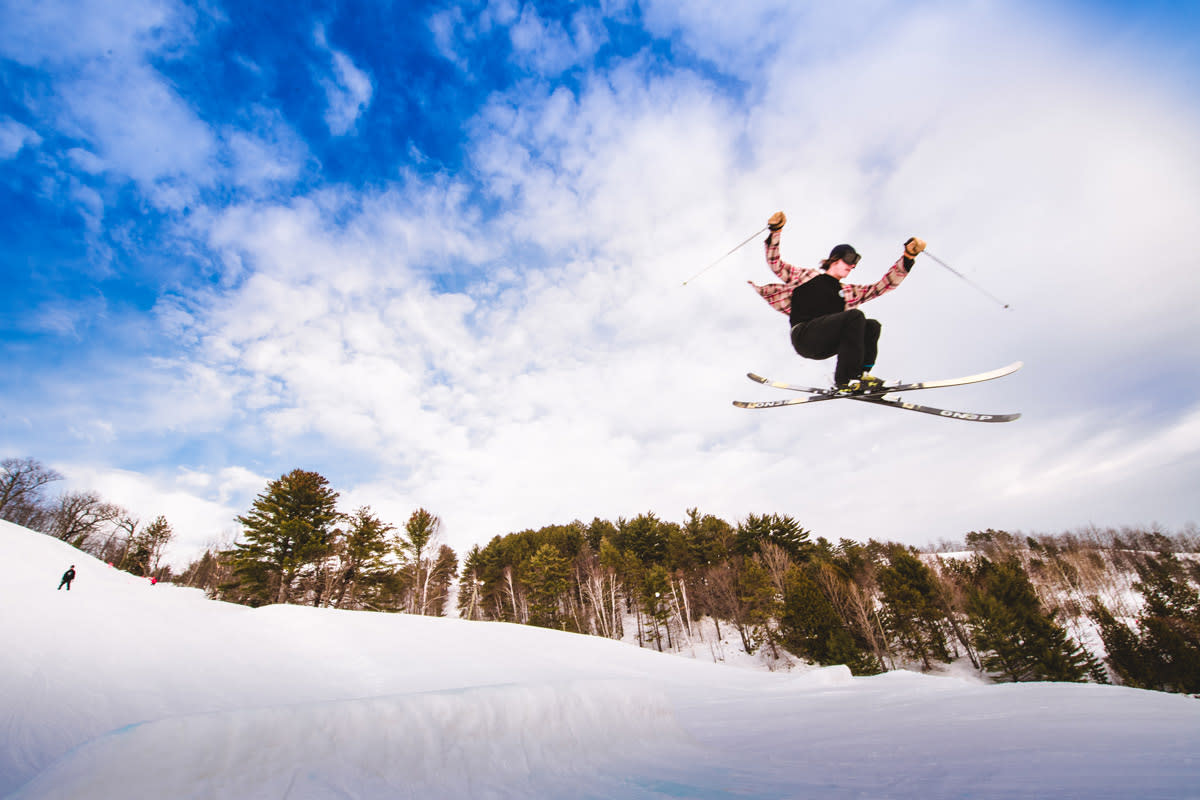 Man doing trick jump with skis