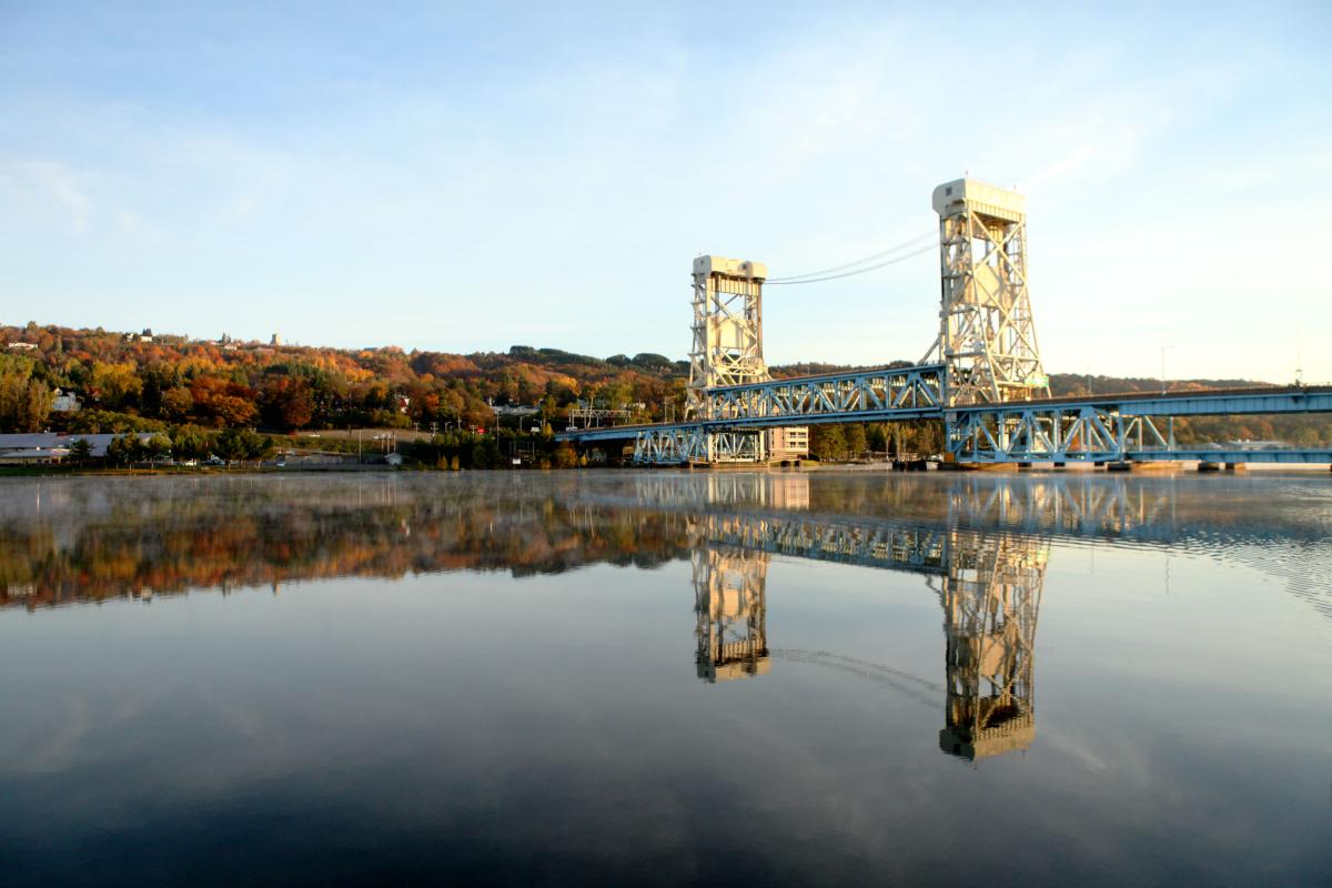 Portage Lake Lift Bridge on a crisp morning with light fog lingering on the surface of the canal.