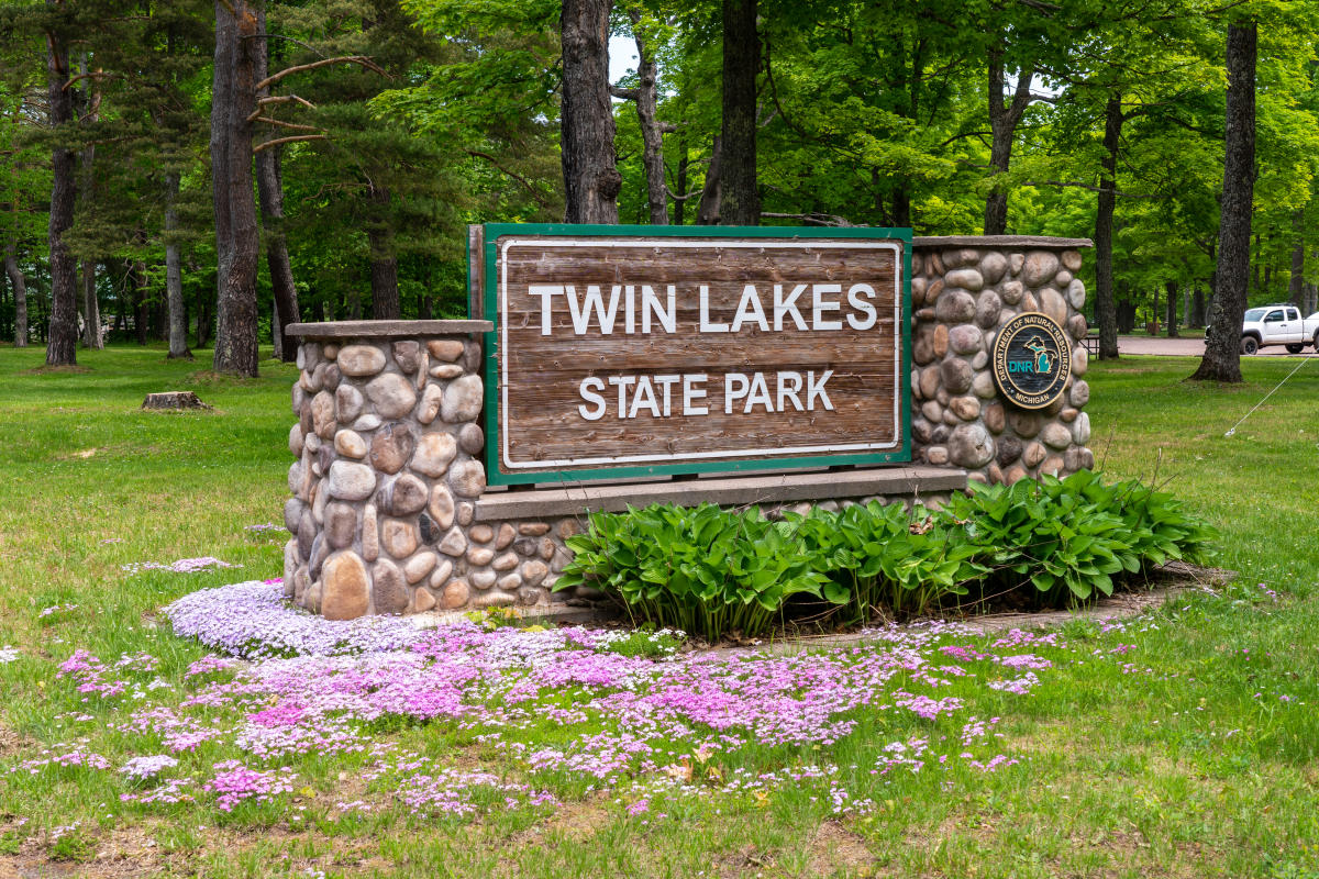 Twin Lakes State Park sign with flowers