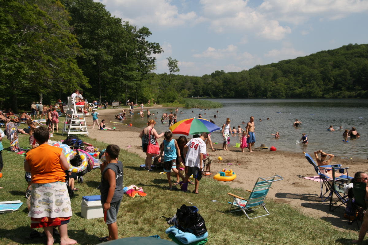 People on the beach and swimming at Merli-Sarnoski Park