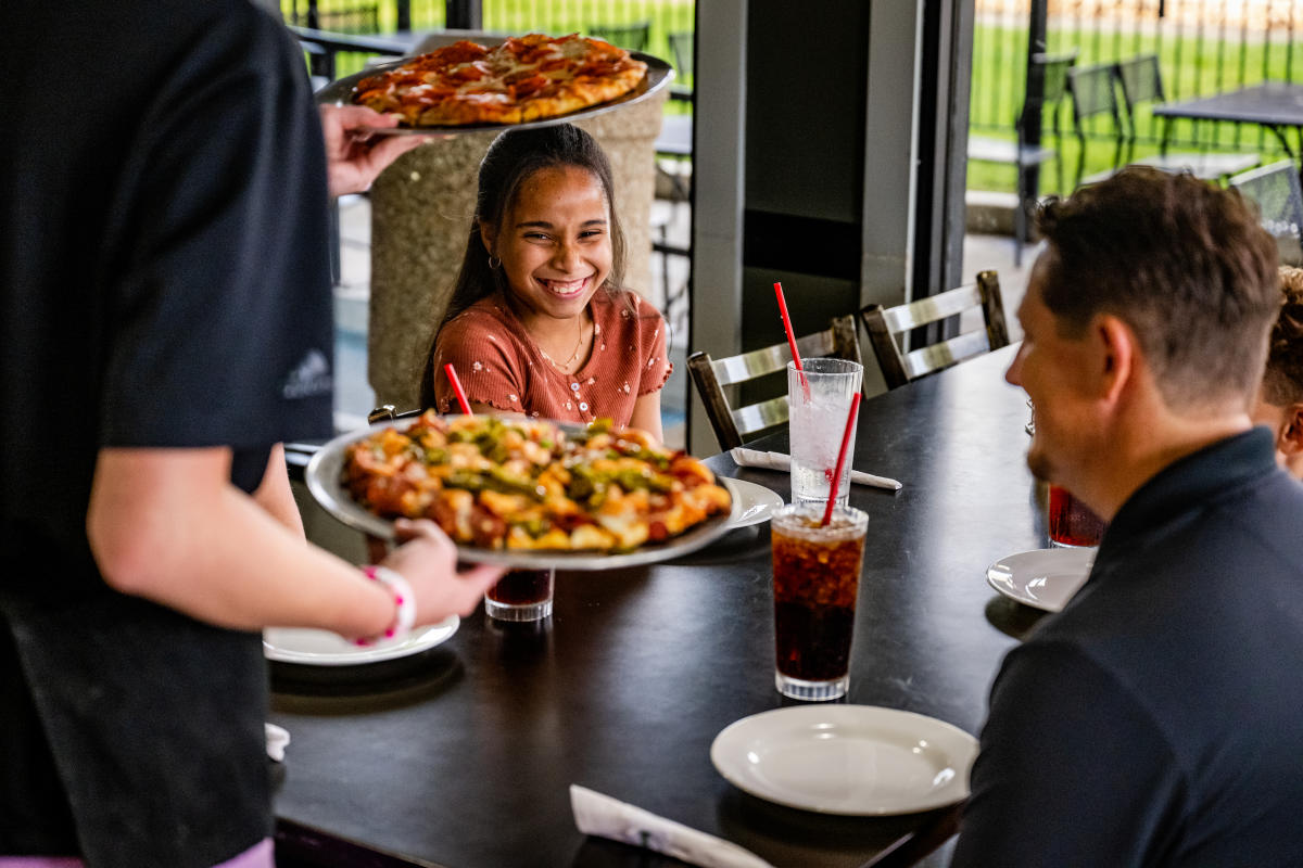 Family of 4 Eating Pizza at Dean-O's Pizza