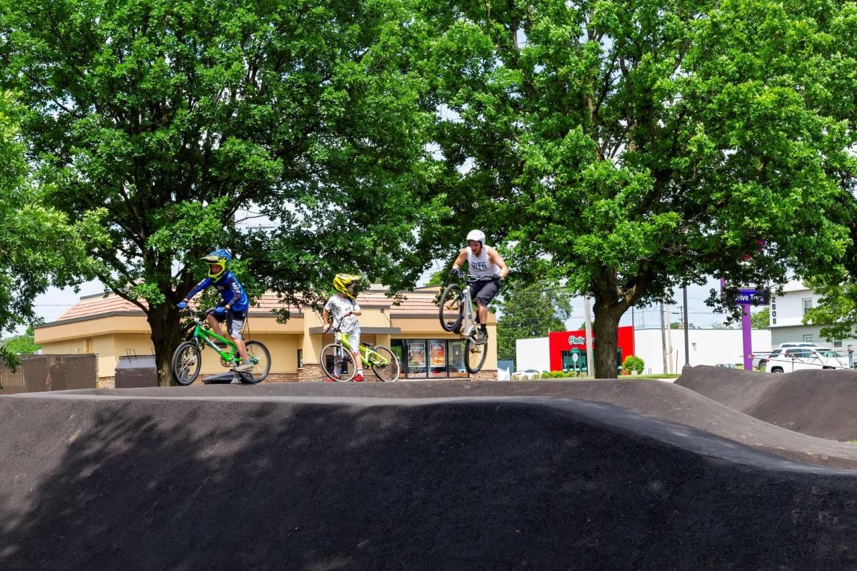 People riding their bikes on the Capital City Family BMX Pump Track