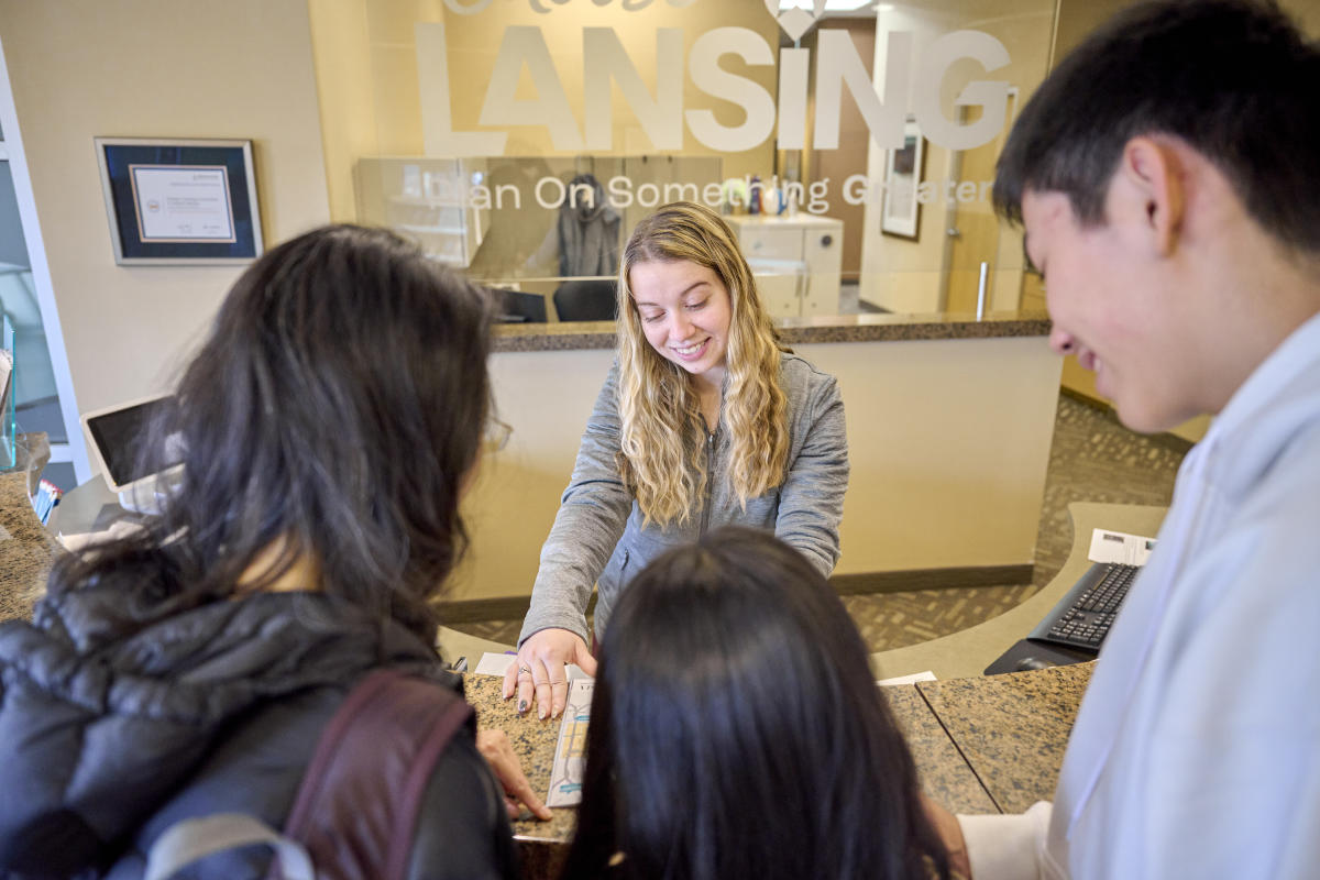 Helping visitors at the Choose Lansing Visitors Center