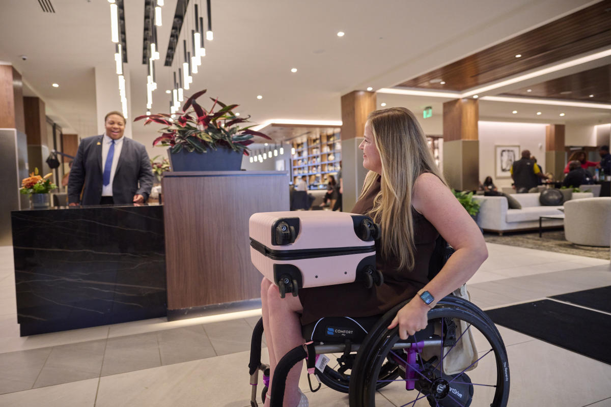 A wheelchair user with her luggage
