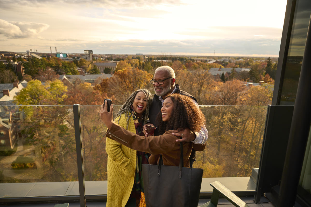 Family taking a selfie with Michigan State campus in the background