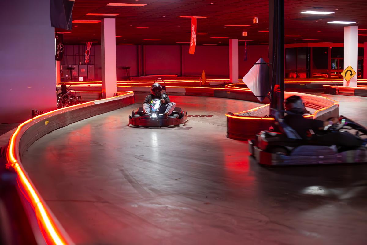 Two Go-karts racing around the track at High Caliber Karting
