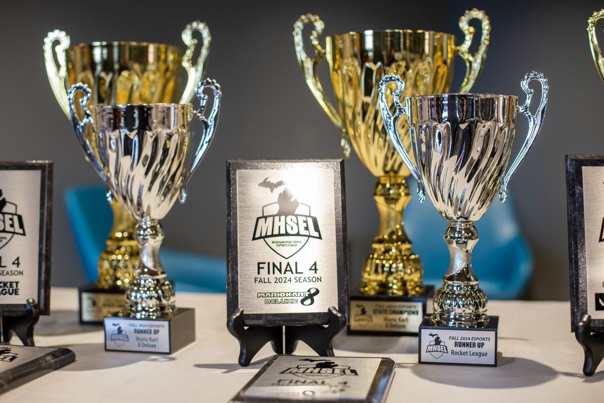 MHSEL esports championships awards and trophies on a table.