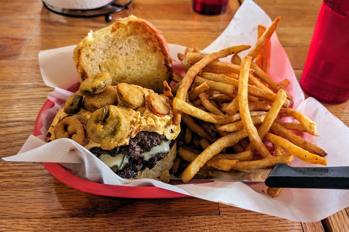A burger and fries in a basket from Meat.