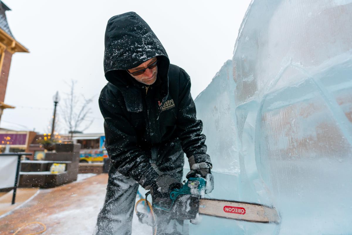 A Mastro Ice Company employee carves a sculpture in Somerset during the 2023 Fire & Ice Festival