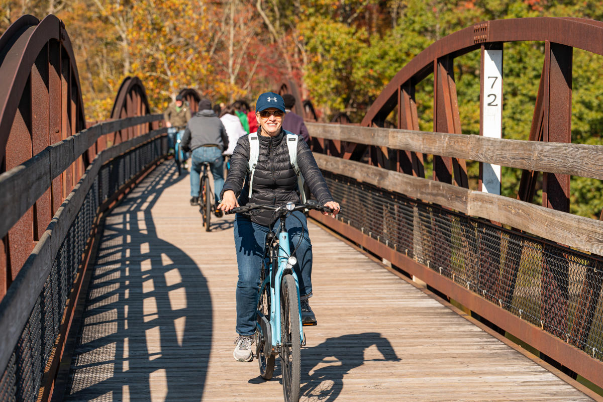 Female biking Great Allegheny Passage in the Fall