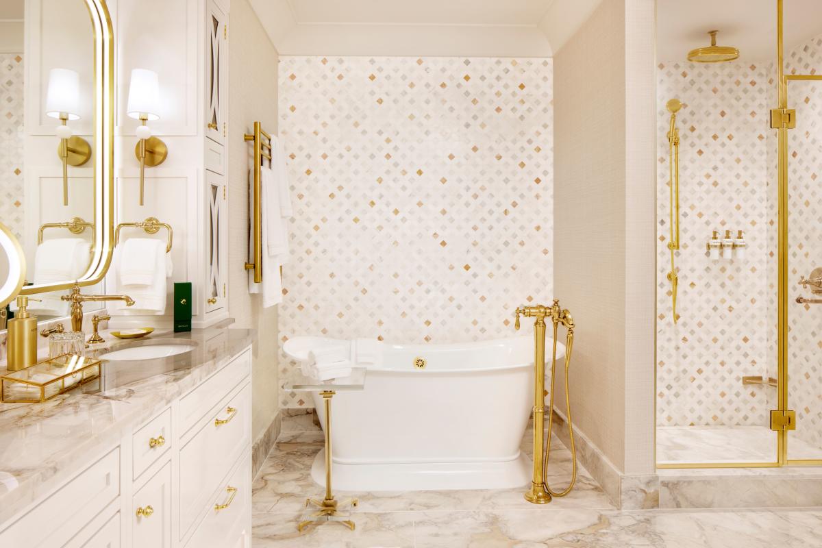 Bathrooms at The Chateau at Nemacolin feature luxurious soaking tubs and elevated fixtures.