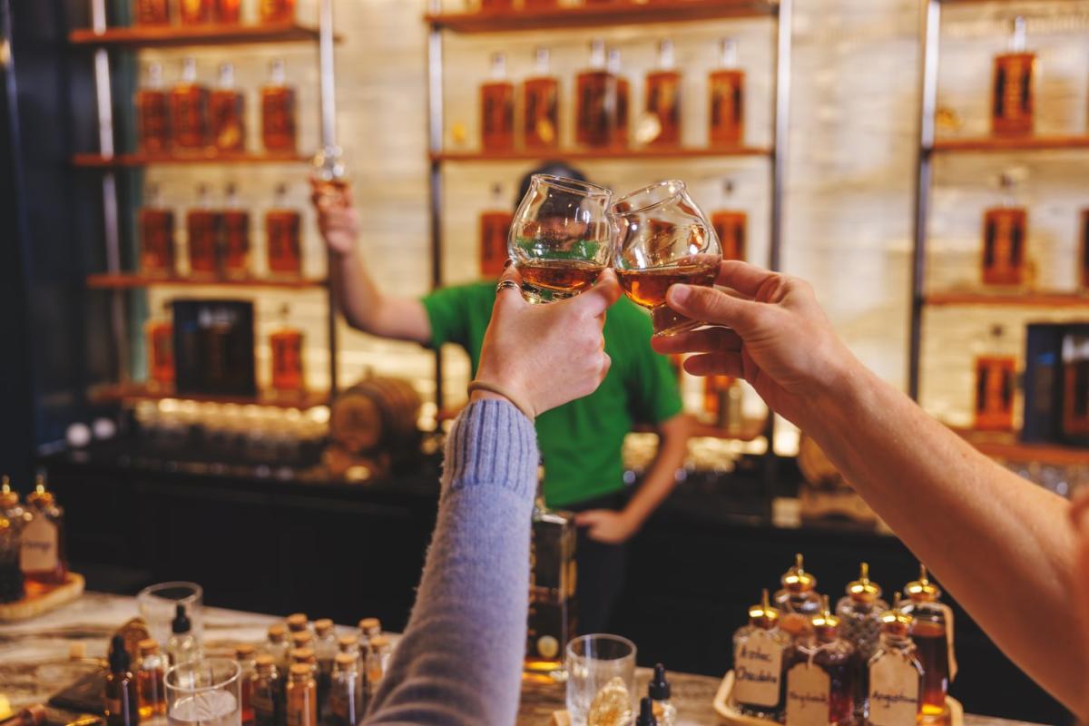Two People cheersing at Fresh Bourbon Distillery Bar