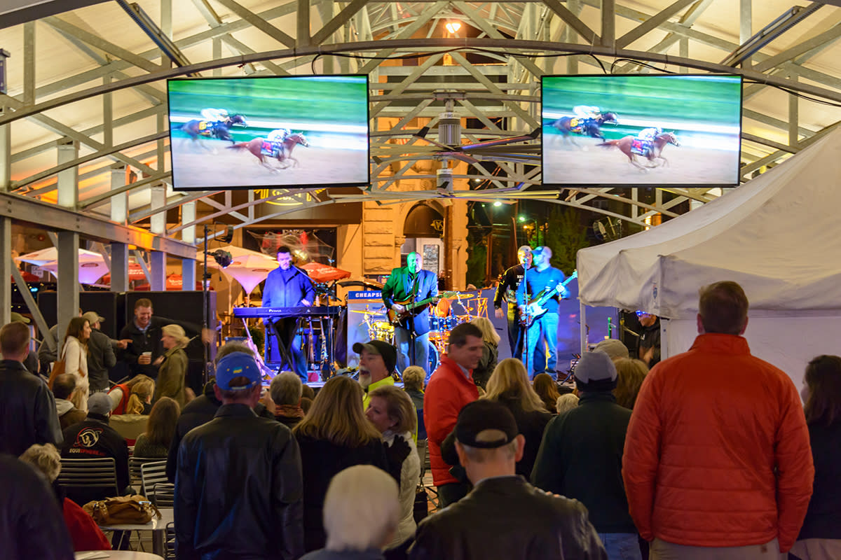 People enjoying live music and horse races at the Breeders' Cup Festival