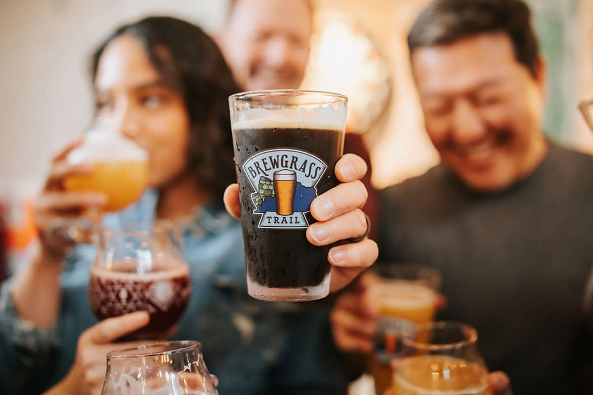 People enjoying beverages on the brewgrass trail