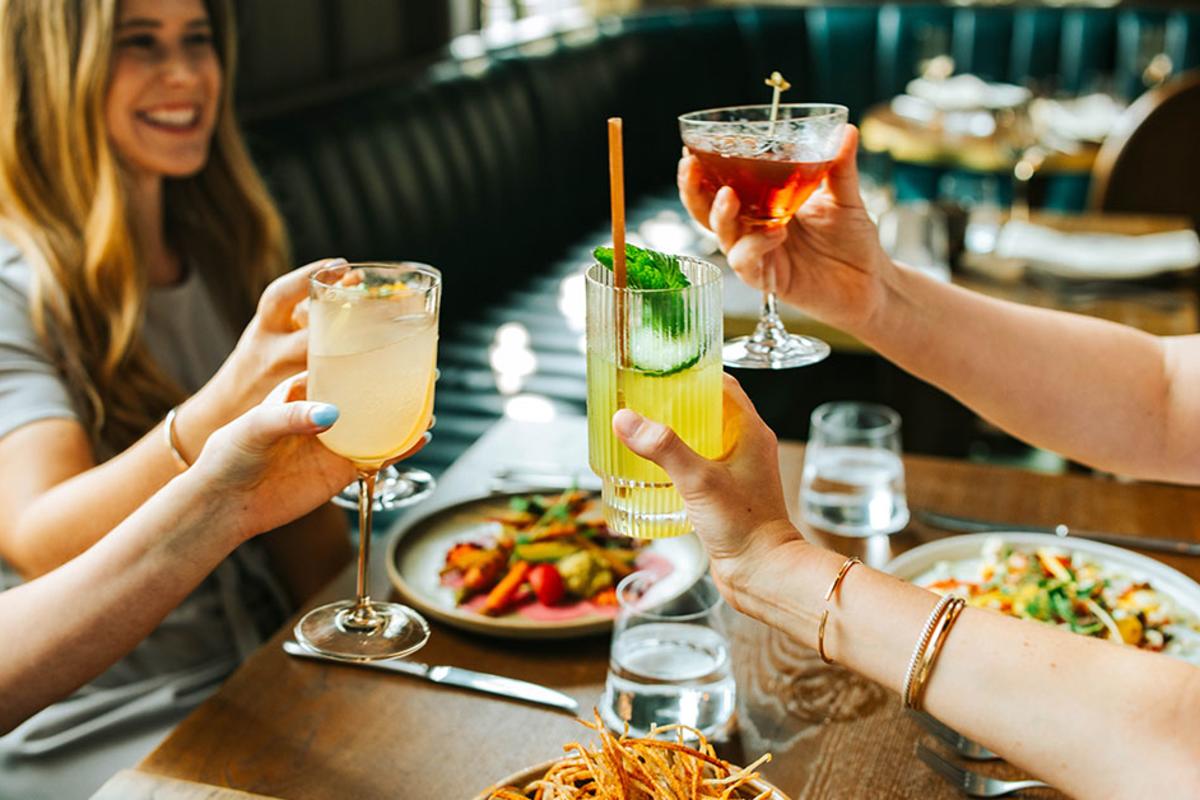 People toasting their drinks at Granddam restaurant in Lexington, Kentucky