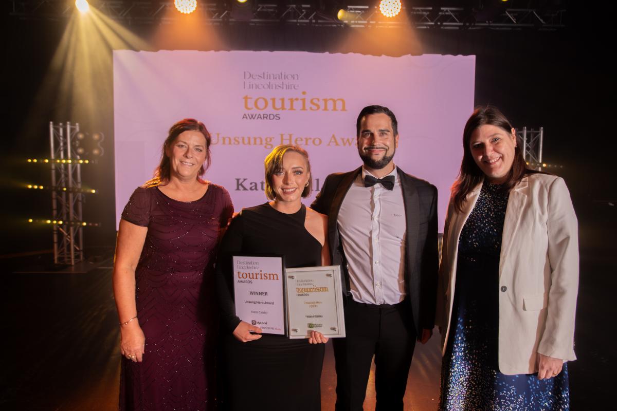 A group of people celebrating a win at the Tourism Awards