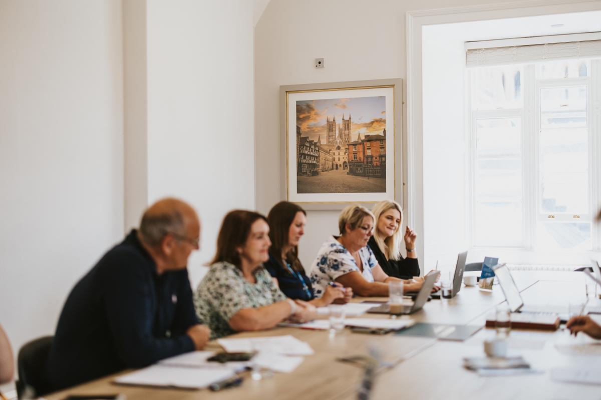 a board meeting of Destination Lincolnshire with people sat together at a table