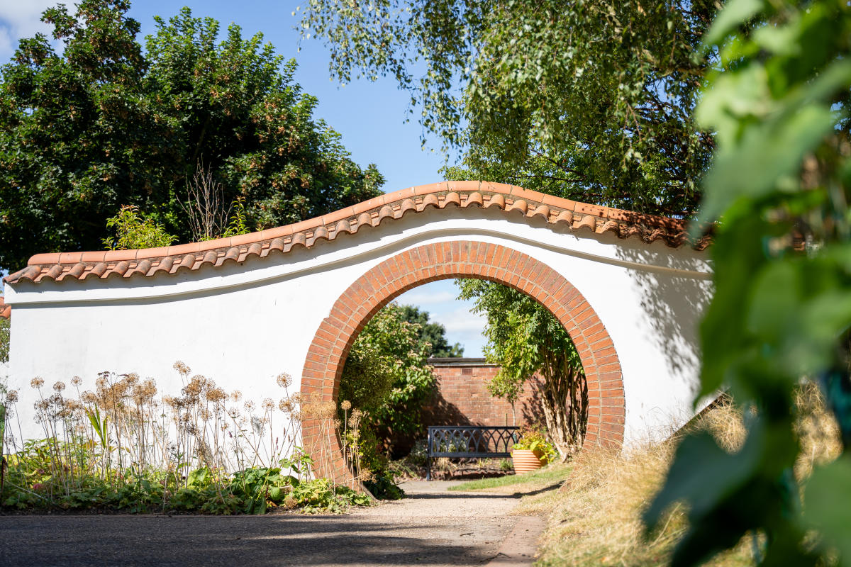 A stone arch in John Dawber Gardens, a community garden in the grounds of The Lawn in Lincoln