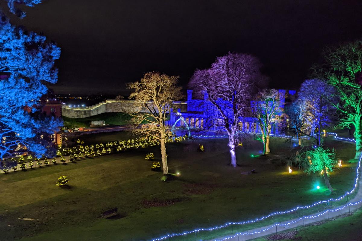 An image of the lawn of Lincoln castle with illuminated trees
