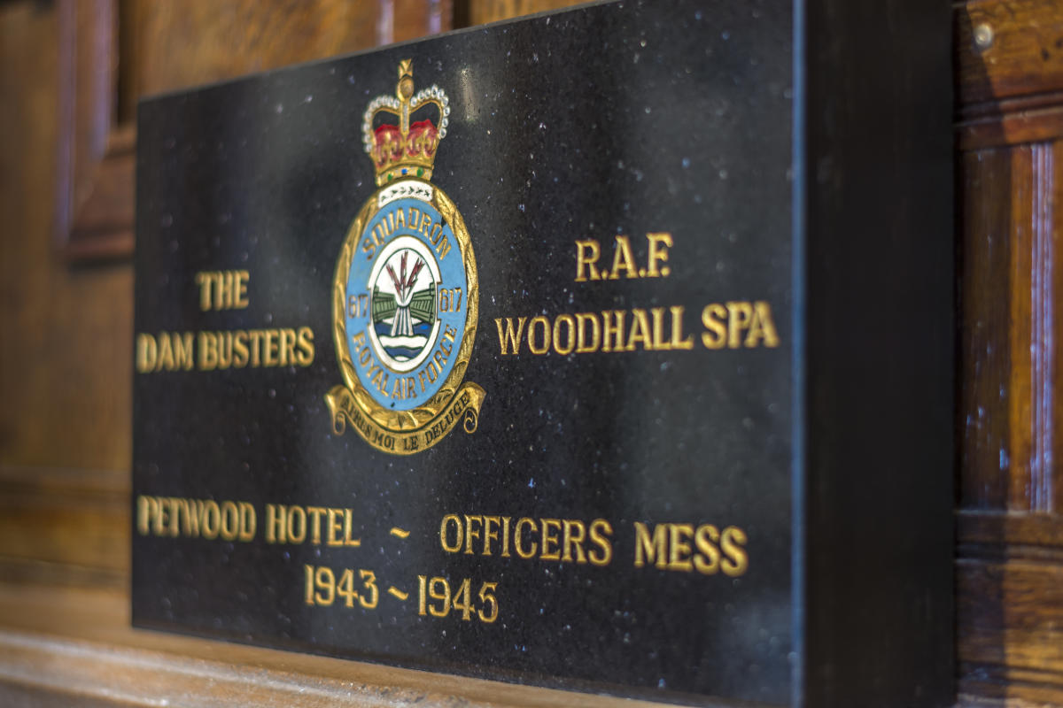 close up of Dambusters plaque with a crest and golden text
