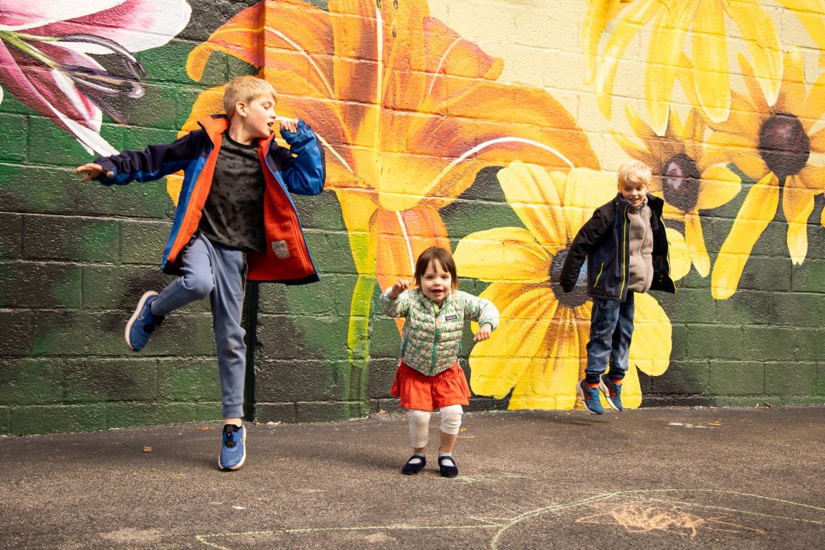 Kids Jumping in Front of Mural