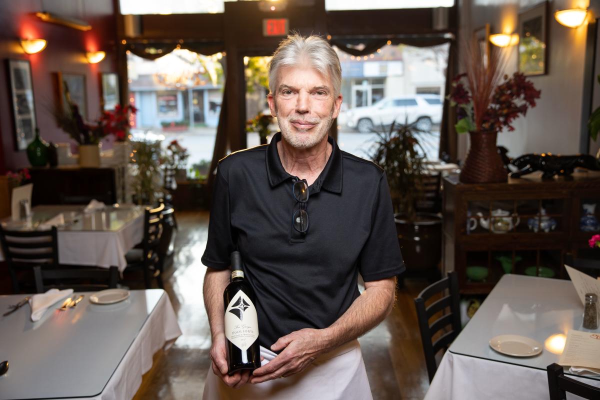 Tim Holding Wine at Questa